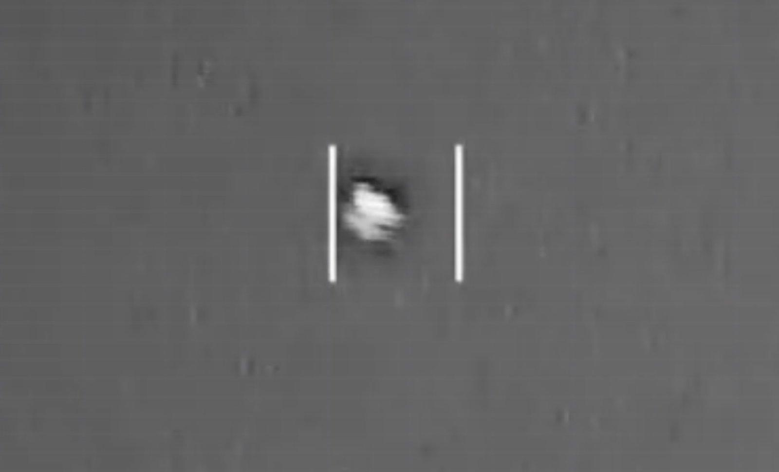 Infrared sensor still from a Department of War UAP video in PURSUE Release 4 showing a small bright object between tracking gates