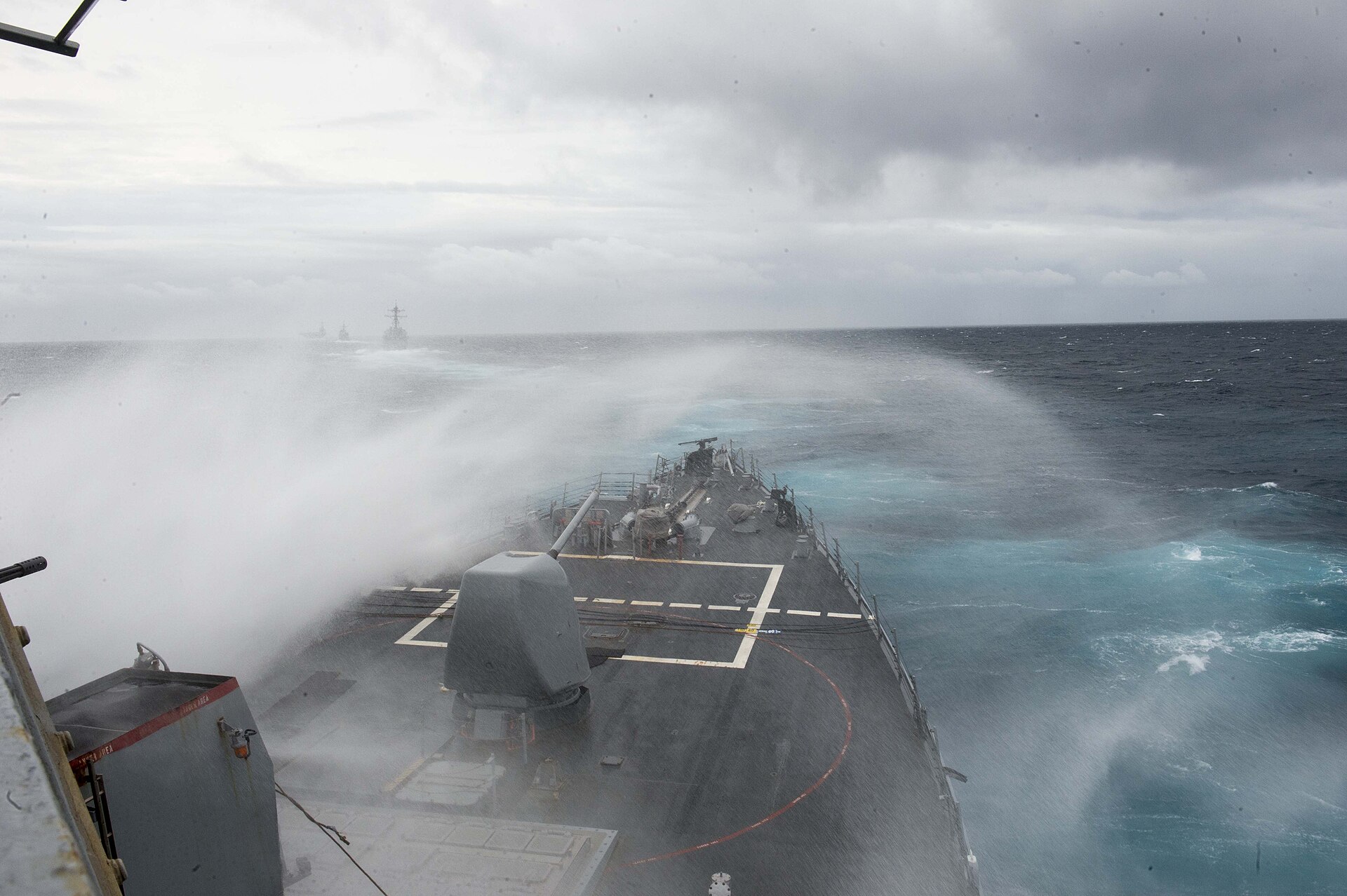 Waves crash over the bow of the destroyer USS Arleigh Burke in the Atlantic Ocean